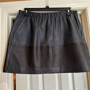 Two tone genuine leather mini skirt.